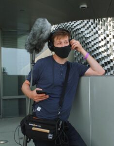 Student Evan Hartney doing sound on set