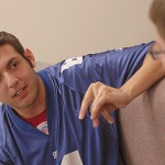 Two students talking on a couch.