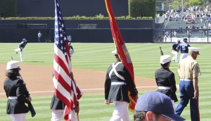 The flag is presented by the Junior ROTC Color Guard from Oceanside High School, one of the DoDEA consortium schools, before the Padres-Dodgers game in San Diego.
