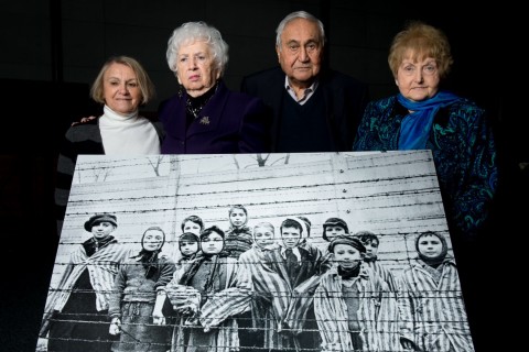Survivors pose with iconic photograph