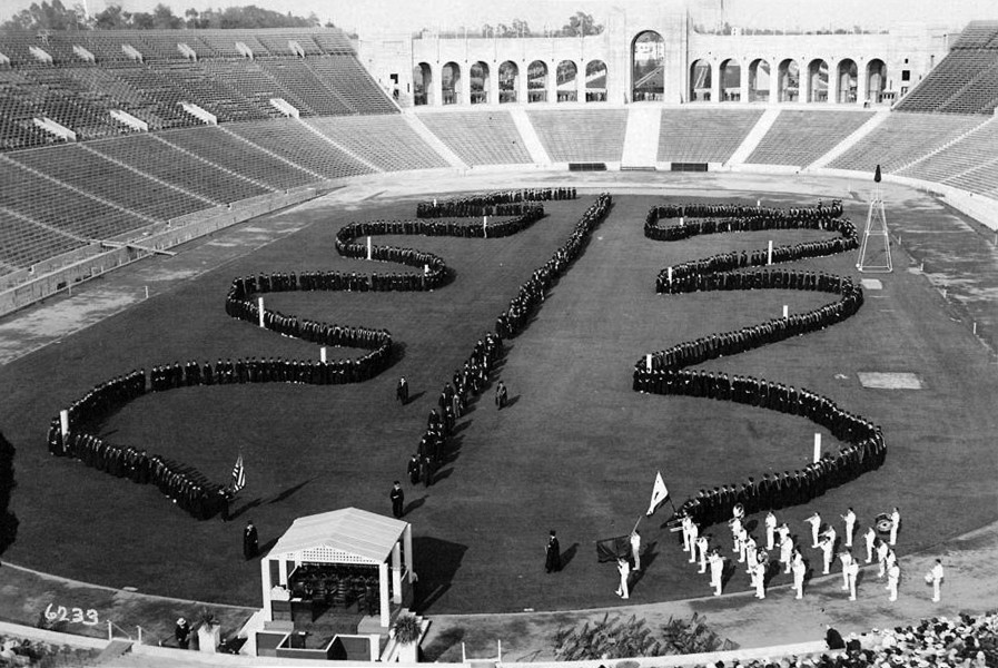 USC commencement photos: 1926 The Academic Serpentine, the President, deans and faculties advance through the rows of the 1354 graduates who receive their diplomas in the Coliseum stadium.