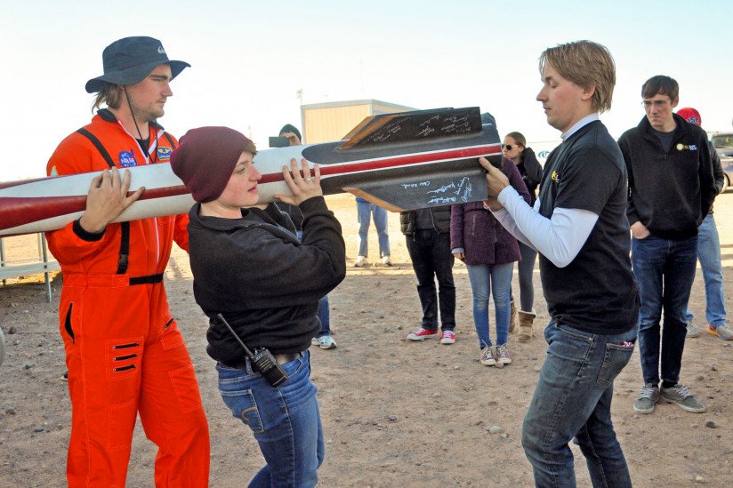 students carrying rocket
