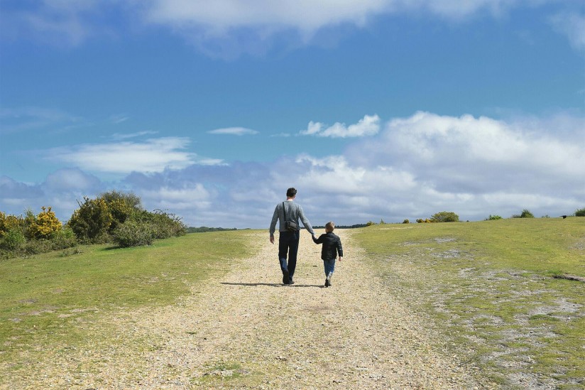 Father and young son walking