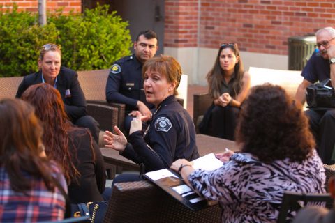 Police Chief Sharon Papa outside Tutor Center talking to a small group of people