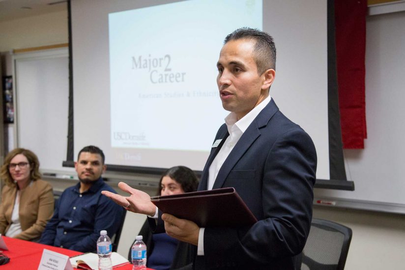 Octavio Avila speaking in front of class