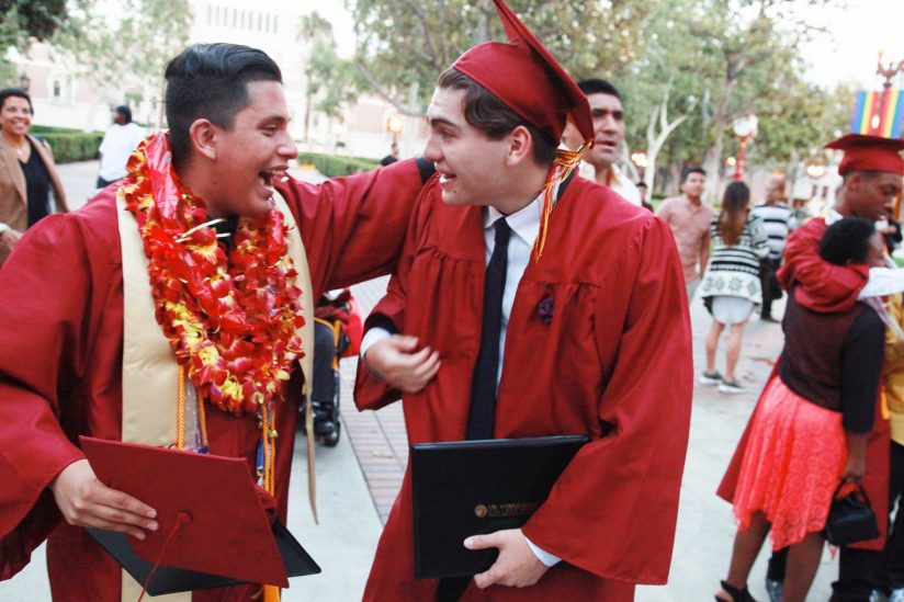Graduates patting each other on the back