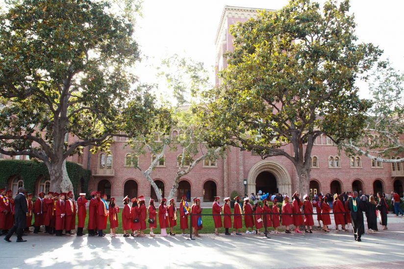 Hybrid high graduates line up in front of Bovard for a ceremony