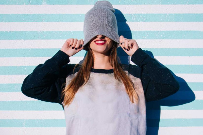 Girl pulling woolen hat over eyes