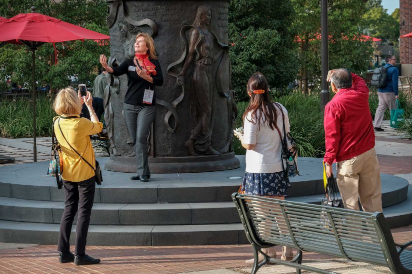 Alumni taking photos in front of Hecuba