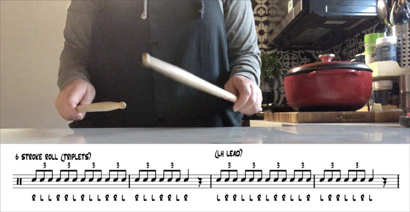 Lauren Ellis tapping beats on her kitchen counter with a pair of drumsticks