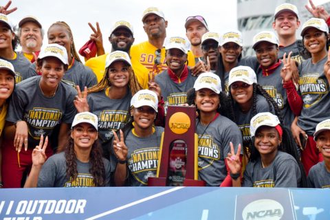 Women’s track and field team with championship trophy