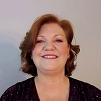 Kathleen Burns Campos in a black blouse against a plain background